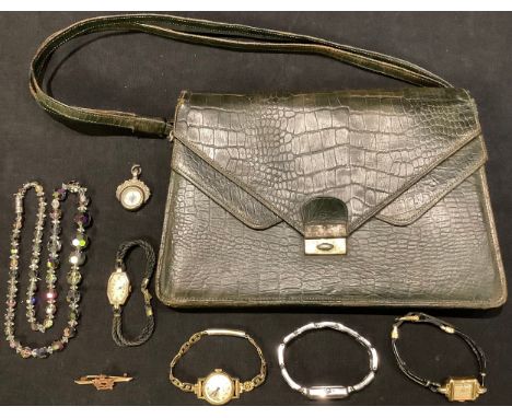 A 9ct rose gold Royal Air Force pin badge, 1.16g; a lady's gold watch; a late 19th century silver compass fob; a snakeskin ha
