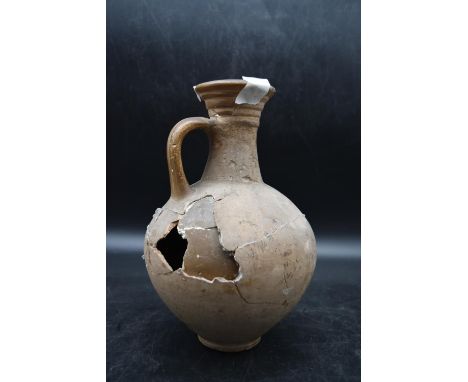 A single handed Roman clay pitcher dated AD 100. Accompanied by provenance. H.25cm