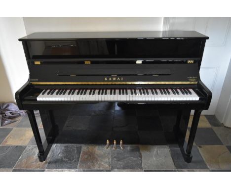 A 2012 Kawai upright piano, model K-2 in a lacquered ebonised case. H.114 W.147 D.56cm