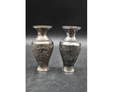 A pair of Chinese silver relief pine tree and figural design vases. Chinese makers mark to the base. Weight. 261g 