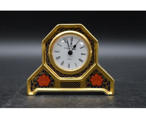 An early 20th century Royal Crown Derby clock with white enamel dial and stylised with gilded border and foliate decoration. 