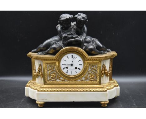 A 19th century French ormolu mantel clock, with a white enamal dial and Roman numerals, signed 'Marshall &amp; Fils A Paris' 