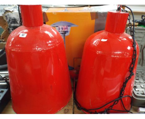 Two large red industrial metal ceiling light fittings approx 2' tall 