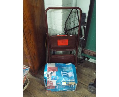 A pair of 2 tread steps, a dog guard for a car, TV bracket, cutting tool and tie down strap