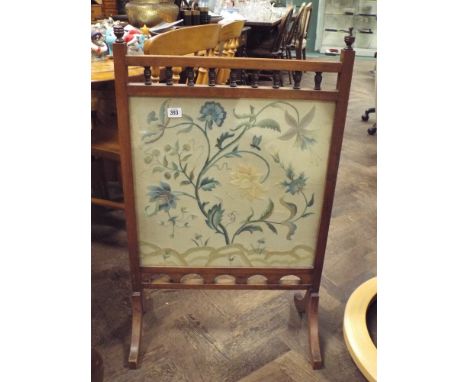 A walnut fire screen with needlework panel 
