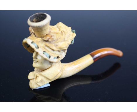 An early 20th century meerschaum cheroot pipe, the bowl carved as a lady wearing a bonnet, 11cm, together with various other 
