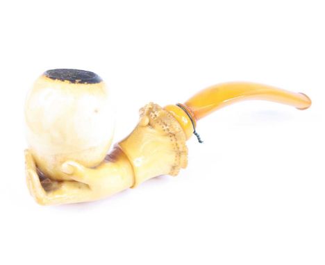 A large 19th century meerschaum pipe, carved as a hand holding the bowl with simulated lace cuff, 17cm, together with one oth