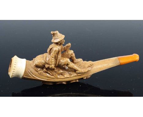 A 19th century cheroot pipe, the stem carved as a huntsman seated with deer and gun in hand, 11cm, together with three other 