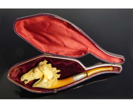 A 19th century meerschaum pipe, the bowl carved as horse's head, having a white metal collar and amber stem, 14cm in Victoria