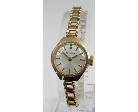 A lady's Nivada 9ct gold cased manual wind wristwatch, on 9ct gold bracelet, 12.4g