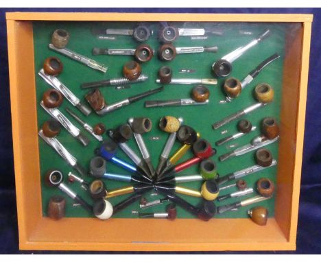 A framed and glazed wall display, depicting examples of various mid 20th century pipe designs to include Aero Kool, Spiral Ko
