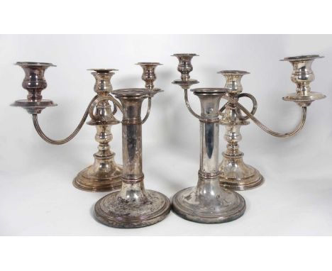 A pair of silver plated three-branch table candelabra, h.22cm; together with a pair of table candlesticks 