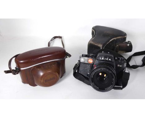 A Leica camera, model R4, together with a Kodak camera