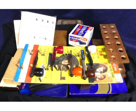 A tray of various pipe smoking paraphernalia to include a wooden pipe rack, Promotional Pipe Smoking from the 1960s, various 