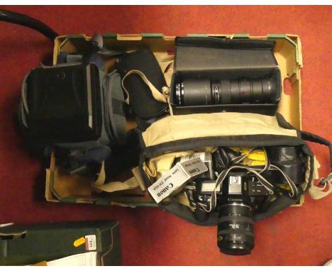 A collection of cameras to include a Canon EOS650, various lenses and camera equipment