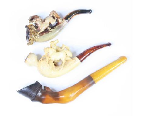 A late 19th century meerschaum pipe, the bowl carved as a horse's hoof with white metal shoe, 14cm, together with two other m