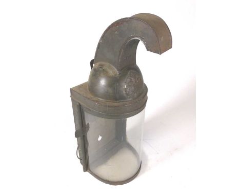 A late 19th century toleware wall light, in the form of a helmet, having a curved glass cover, h.46cm 