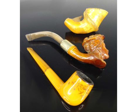 A 19th century meerschaum pipe, the large bowl carved as a horse's hoof, 8cm, together with a treacle glazed poets pipe of a 