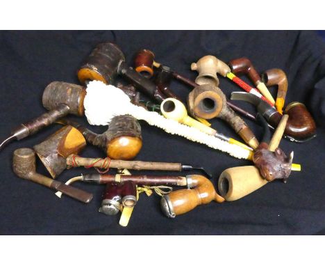 A Large Meerschaum pipe, carved in the form of Bacchus, amber stem, 38cm, together with amber and silver collared pipes many 