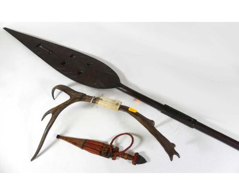An African carved hardwood ceremonial spear, length 151cm; together with a tribal dagger, fashioned from an antler; and one o