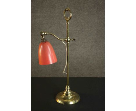 An Edwardian brass adjustable desk lamp with orange bell shaped shade. H.58 W.23cm. 