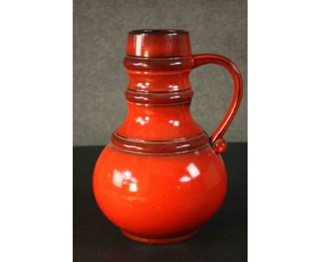 A large vintage West German orange glazed ceramic jug. Numbered to the base. H.36 Dia.25cm. 