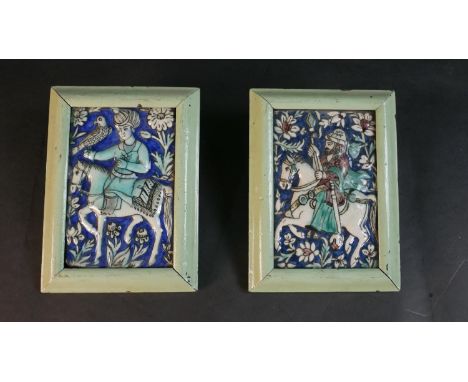 A pair of framed antique Qajar Persian hand painted and polychrome glazed ceramic tiles of warriors on horseback. H.23 W.17cm