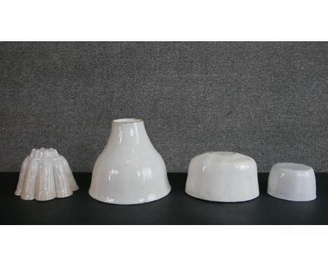 Four 19th century ceramic jelly moulds, one with an ornate tiered design. H.19.5 W.21 D.22cm (largest) 