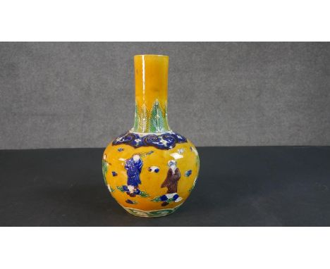 A 19th century Chinese Sancai yellow ground ceramic vase with figural design. Six character mark to base. H.32cm 