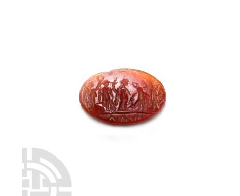 2nd-3rd century A.D. A bifacial oval-shaped carnelian gemstone with bevelled edge, the obverse engraved with a scene composed