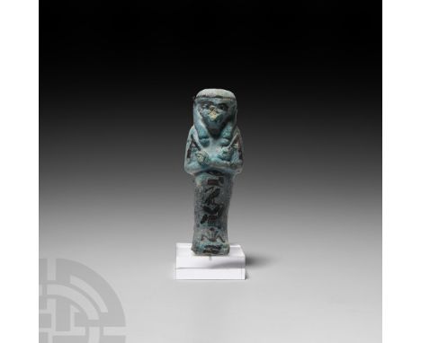 Third Intermediate Period, 21st Dynasty, 1069-943 B.C. A blue-glazed composition shabti with detailing in a darker pigment to
