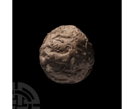 Mid 6th-mid 4th millennium B.C. A spherical ceramic bulla envelope containing multiple clay tokens which can be heard rattlin