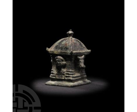 1st-2nd century A.D. A copper-alloy pyxis of architectural form, a column to each corner, and a bull's head to two of the sid