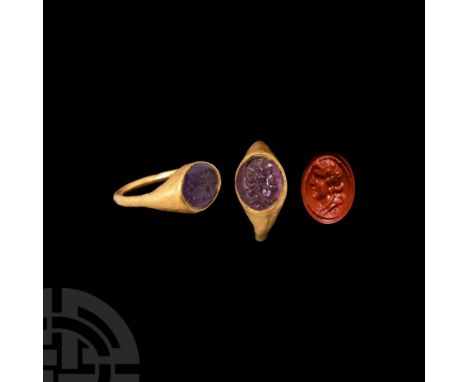 1st century B.C. A gold ring comprising a round-section gold hoop and inset a later amethyst cabochon, intaglio portrait bust