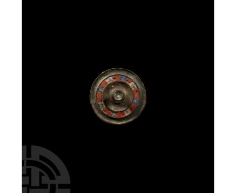 2nd century A.D. A circular plate brooch with decorative notching to the outer edge and pin lugs, pin and catchplate to rever