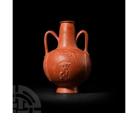 North Africa, circa 3rd century A.D. A globular red slip ware amphoriskos or bottle with tapering neck, everted rim, two D-se
