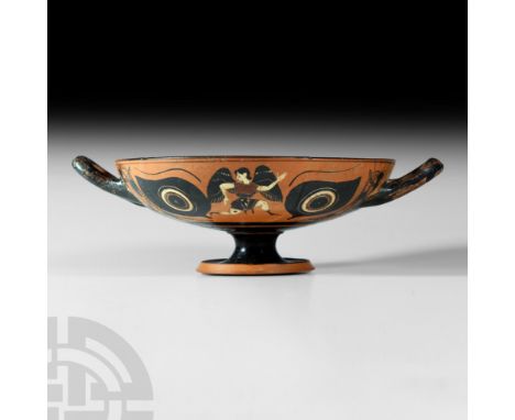 Circa 520-500 B.C. A terracotta black-figure kylix composed of a D-section bowl and stemmed foot, bowl exterior decorated wit