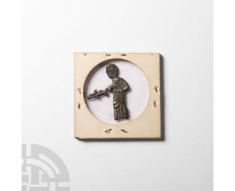 14th century A.D. A significant part of a pewter pilgrim's badge depicting the robed executioner of Thomas, 2nd Earl of Lanca
