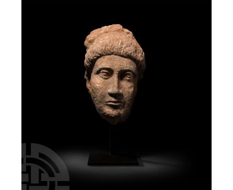 4th-5th century A.D. A life-size limestone head of a man characterised by an elongated oval face and hieratic features, slend