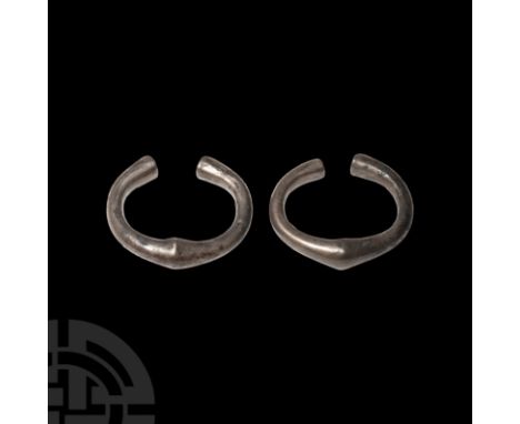 Circa 5th-4th century B.C. A matching pair of heavy silver penannular bracelets, each composed of a D-section body with expan
