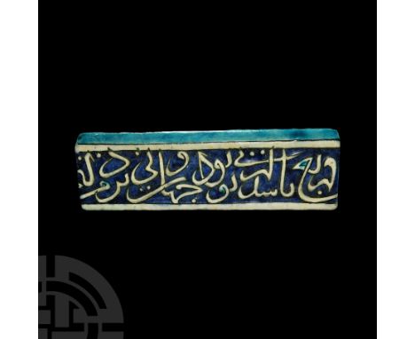 15th-16th century A.D. A rectangular glazed ceramic tile with bevelled upper edge, with part of a Qur'anic inscription; stone