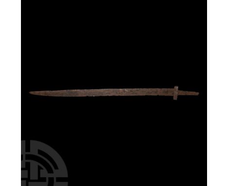 Late 5th-early 6th century A.D. A rare long seax, with a finely tapered blade with traces of battle nicks; boat-shaped cross 