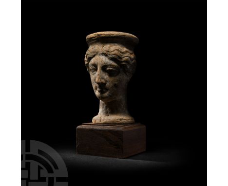 5th-3rd century B.C. A hollow-formed ceramic female head, modelled in the round wearing a polos, with wavy hair and semi-natu