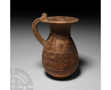 Circa 7th century B.C. An olpe with ovoid body characterised by typical small wheel-shaped elements on the intersection betwe