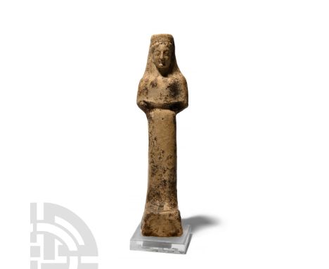 5th century B.C. A terracotta figure modelled as a female kore standing on an integral plinth, wearing a polos, semi-naturali