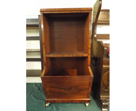 A Walnut Bookcase with Magazine Shelf on Brass Casters. 