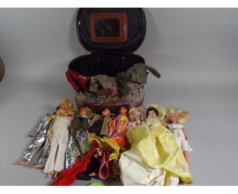 A Make-Up Bag Containing Barbie Dolls Action Man and Accessories.