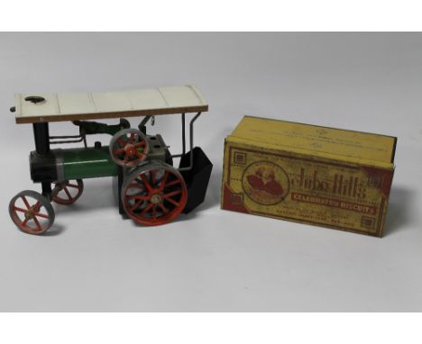 A MAMOD LIVE STEAM TRACTION ENGINE together with a John Hill's biscuit tin