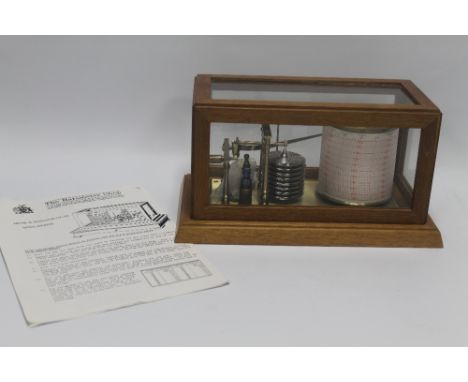 A DISPLAY BAROGRAPH with glazed oar framed cover together with a quantity of related paperwork from 'The Barometer Shop'