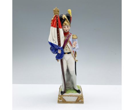 Hand painted figure of French soldier holding a large flag. Light blue, red, white, yellow and gilded colorations. Blue crown